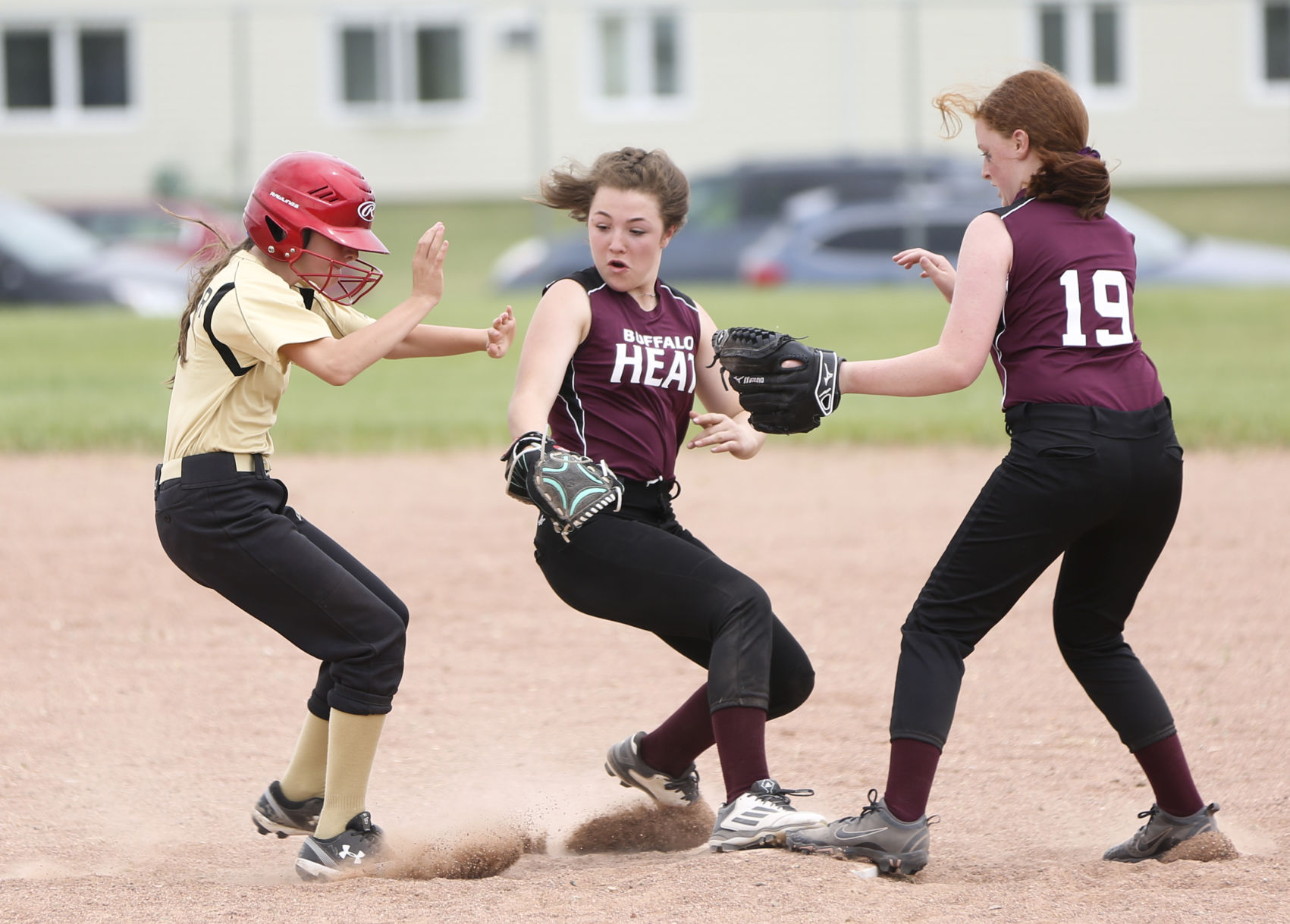 Buffalo’s Cooper Harness, center, tags second base and Sheridan’s Sofia Spomer